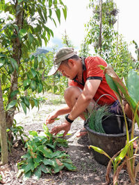 Full length of man wearing hat against trees white pepper