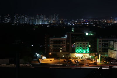 Illuminated city against sky at night