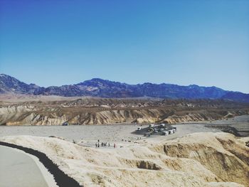 Scenic view of desert against clear blue sky