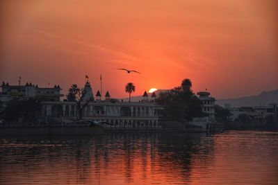 View of lake against orange sky