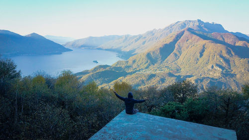 Man on mountain against clear sky