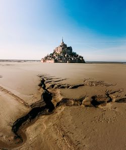 View of palace at beach against blue sky during sunny day