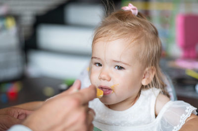 Portrait of cute baby eating food