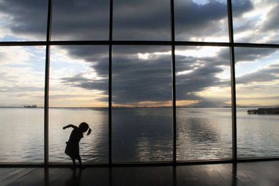 Man standing by sea against sky