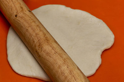 Close-up of bread on table against orange background