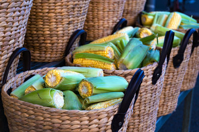 Close-up of corns in baskets for sale at market stall