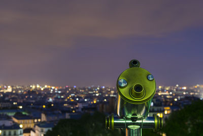 Close-up of illuminated cityscape against sky