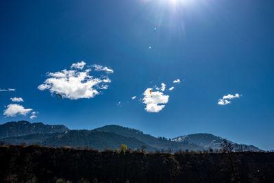 Scenic view of mountains against blue sky