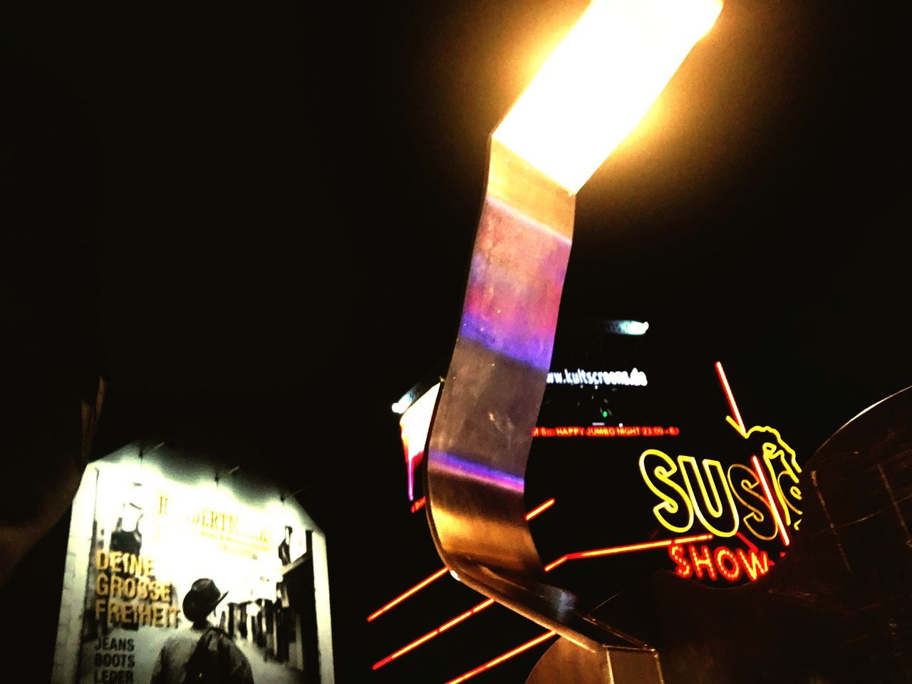 NEON SIGN ON WALL AT NIGHT