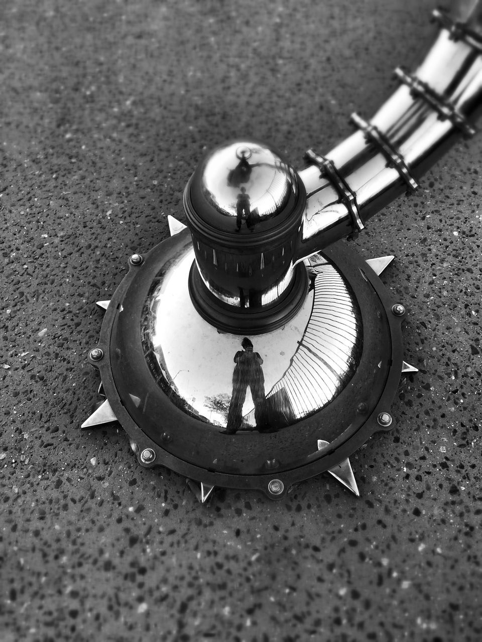 high angle view, metal, street, close-up, day, childhood, outdoors, metallic, shadow, selective focus, circle, focus on foreground, single object, leisure activity, sunlight, reflection, equipment