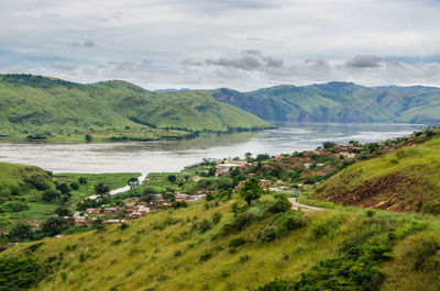 Scenic view of sea and mountains against sky