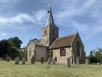 View of cemetery and building against sky