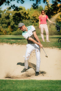 Golfer playing from the sand trap