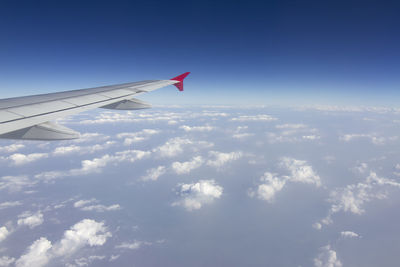 Aerial view of airplane flying in sky