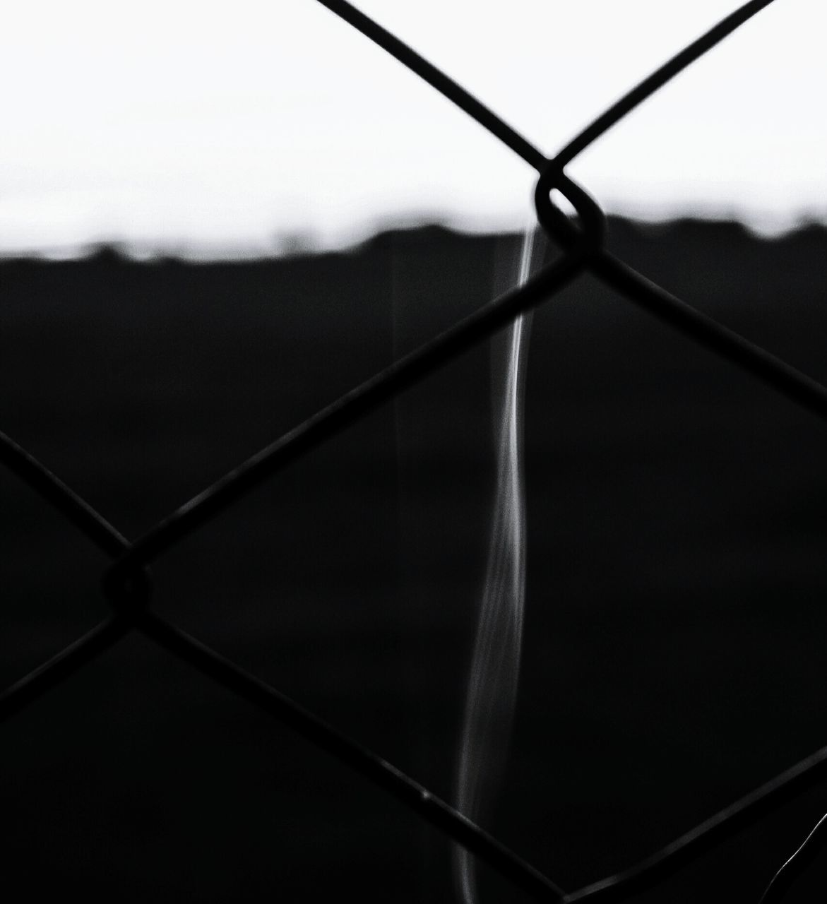 chainlink fence, fence, black, black and white, line, wire, monochrome, no people, wire mesh, monochrome photography, security, metal, sky, protection, focus on foreground, light, wire fencing, close-up, nature, darkness, outdoors, day, circle, white, wing