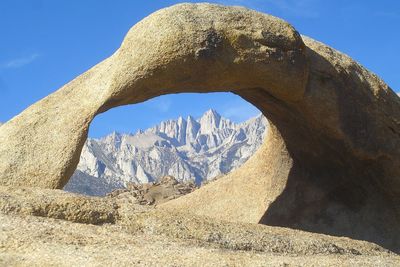 Low angle view of mountain against blue sky