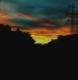 Silhouette landscape against sunset sky