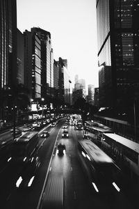 Traffic on city street and buildings against sky