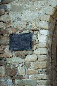 Close-up of text on brick wall