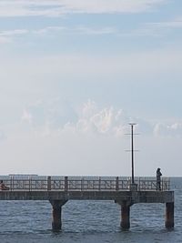 Pier over sea against sky