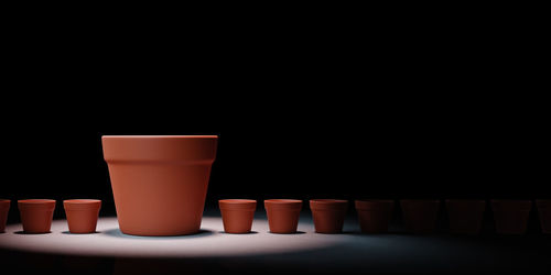 Close-up of coffee cup on table against black background