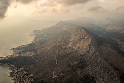 Aerial view of rocky mountains against sky