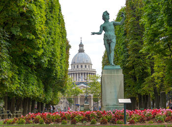 Low angle view of sculpture amidst trees at le jardin du luxembourg