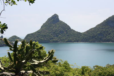 Scenic view of sea and mountains against clear sky