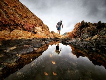 Rear view of man walking on mountain