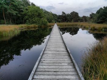 Pier over lake against sky