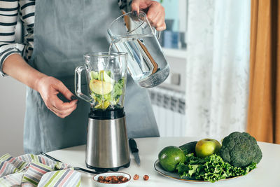 Midsection of man preparing food at home