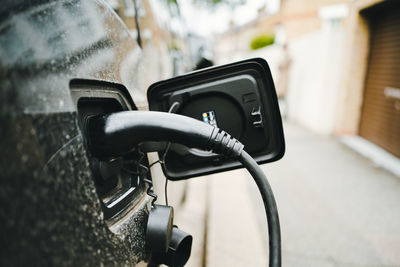 Close-up of black electric car being charged