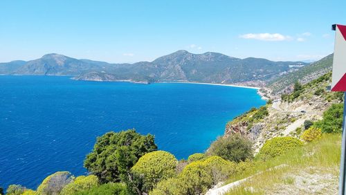 High angle view of sea and mountains against sky