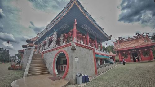 Low angle view of temple against cloudy sky