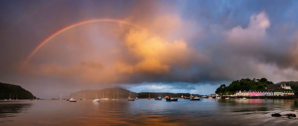 Scenic view of rainbow over sea against sky