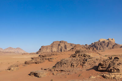 Scenic view of desert against clear blue sky