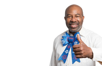 Portrait of a smiling young man against white background