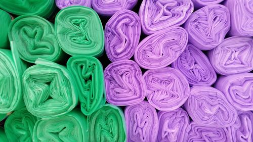 Full frame shot of purple and green garbage bags for sale at market stall