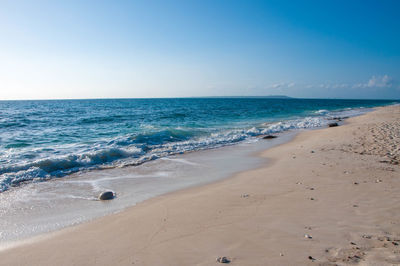 Scenic view of beach against clear sky