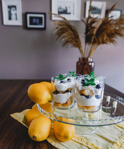 Homemade tiramisu with lemons served on table. top view of delicious dessert in glass cups.