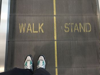 Low section of woman standing on tiled floor