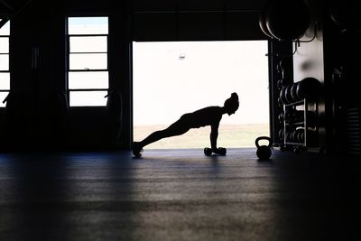 Silhouette woman doing pushups