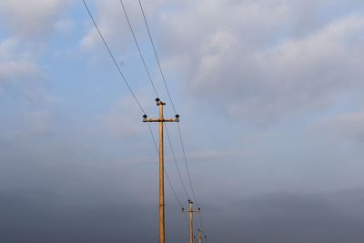 Low angle view of electricity pylon against sky