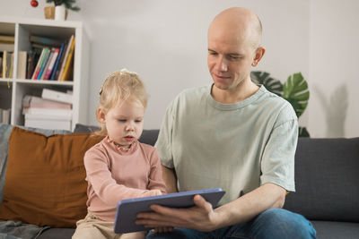 Portrait of boy using digital tablet at home