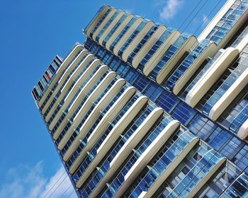 Low angle view of skyscrapers against clear blue sky