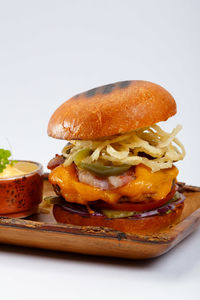 Close-up of burger against white background