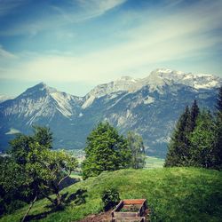 Scenic view of mountains against cloudy sky