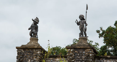 Low angle view of statue against sky