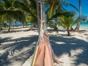 Low section of woman relaxing on beach