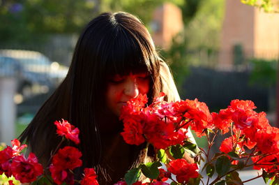 Close-up of young woman with flowers